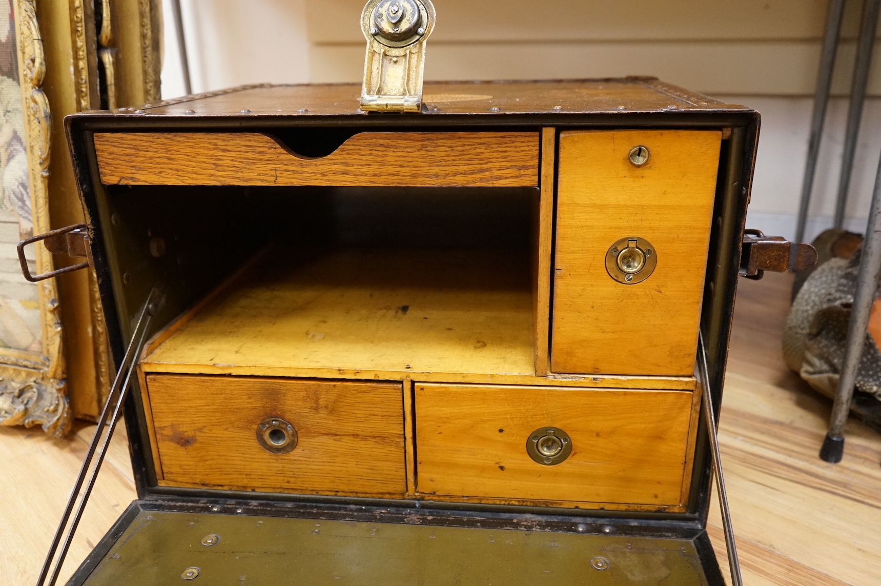 A Hartman Trunk Company metal travelling secretaire with The Grand Hotel, Paris label, with key, 52cm wide